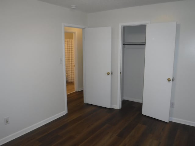 402 Parliment Rd, Martinez, GA 30907 - unfurnished bedroom featuring dark wood-style floors and a closet