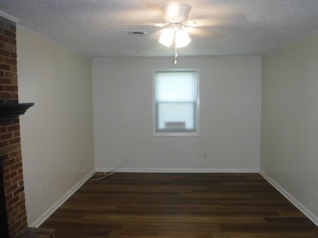 402 Parliment Rd, Martinez, GA 30907 - spare room with dark wood-style flooring, a textured ceiling, a ceiling fan, ornamental molding, and a brick fireplace