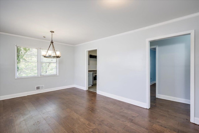 unfurnished room with a chandelier, crown molding, dark wood finished floors, and baseboards