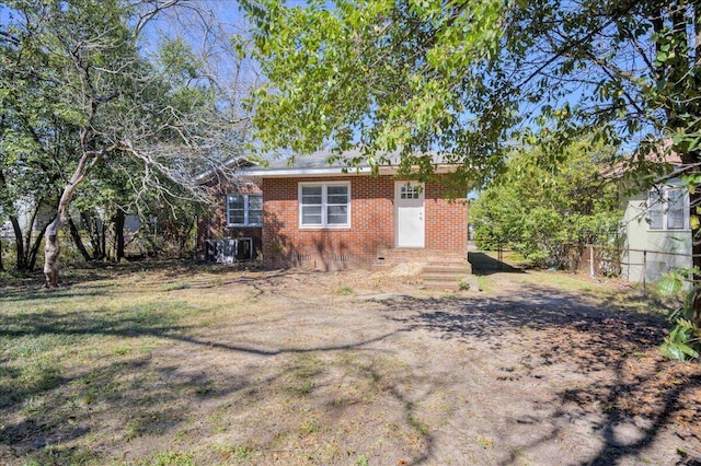 exterior space featuring brick siding and fence