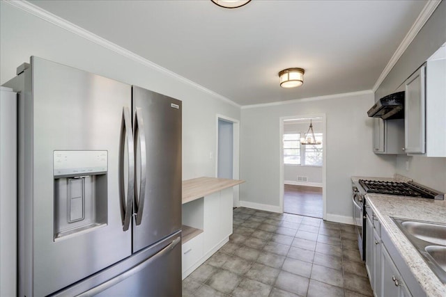 kitchen featuring stainless steel appliances, light countertops, crown molding, and ventilation hood