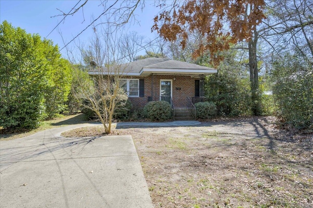 view of front of home featuring a porch and brick siding