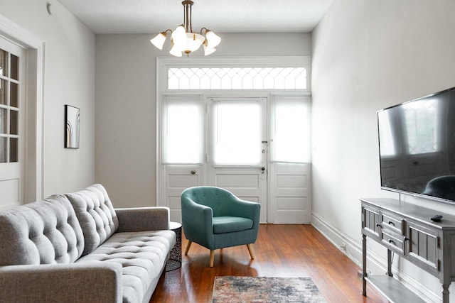 living room featuring wood-type flooring and a chandelier