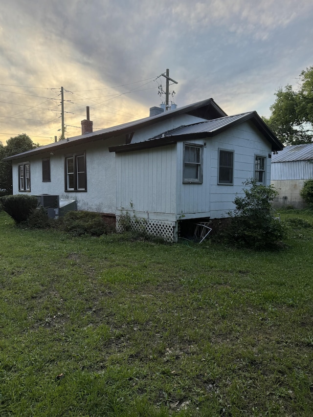912 Holden St, Augusta, GA 30904 - back of house at dusk featuring a chimney and a yard