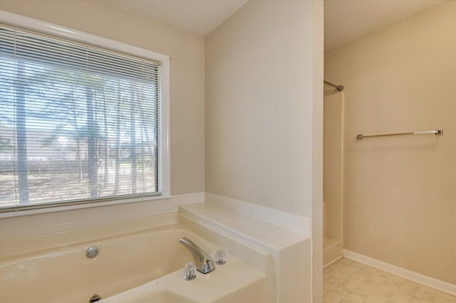 full bath with a tub to relax in, baseboards, a shower, a textured ceiling, and tile patterned floors