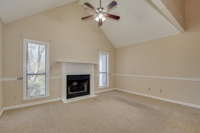 unfurnished living room with a tiled fireplace, carpet, baseboards, and ceiling fan