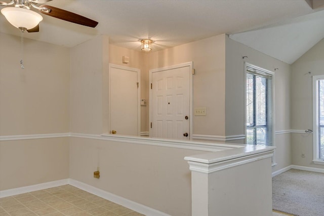 interior space with lofted ceiling and baseboards