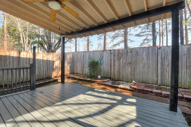 wooden terrace featuring ceiling fan and a fenced backyard