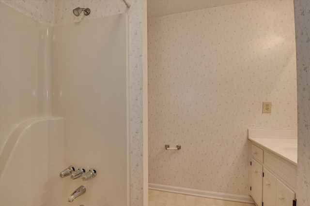 full bathroom featuring wallpapered walls, vanity, tub / shower combination, and baseboards