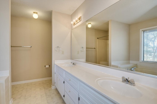 full bathroom with a sink, baseboards, a bathtub, and double vanity