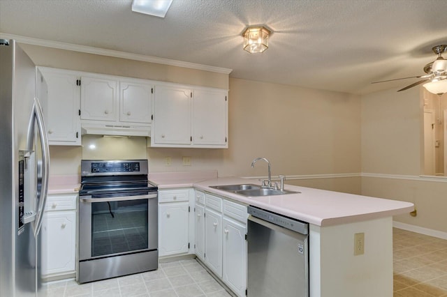 kitchen featuring a peninsula, a sink, stainless steel appliances, under cabinet range hood, and white cabinetry