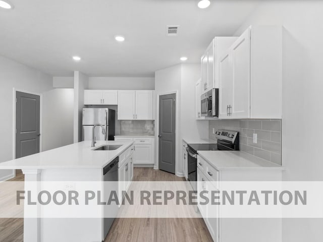 1305 Newbern Dr, Grovetown, GA 30813 - kitchen featuring stainless steel appliances, wood finished floors, white cabinetry, recessed lighting, and an island with sink