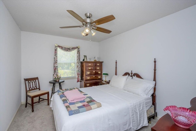 bedroom with light colored carpet and a ceiling fan