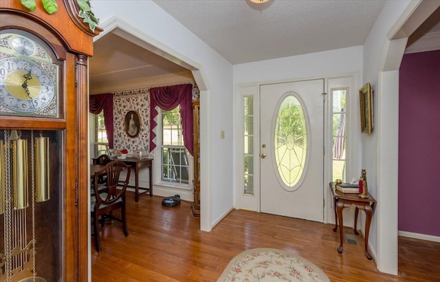 foyer featuring wood finished floors and baseboards