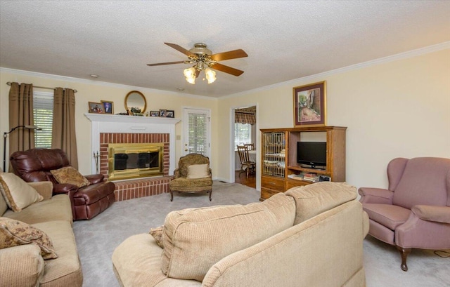 living area with a healthy amount of sunlight, ornamental molding, a ceiling fan, and light colored carpet