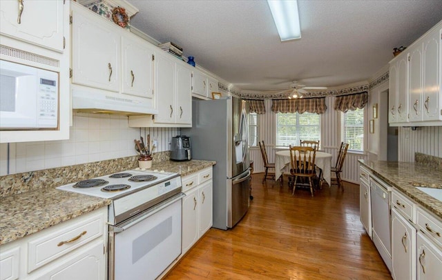 kitchen featuring white cabinetry, ceiling fan, under cabinet range hood, light wood finished floors, and white appliances