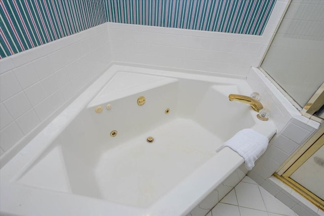 bathroom featuring wallpapered walls, tile patterned flooring, and a whirlpool tub