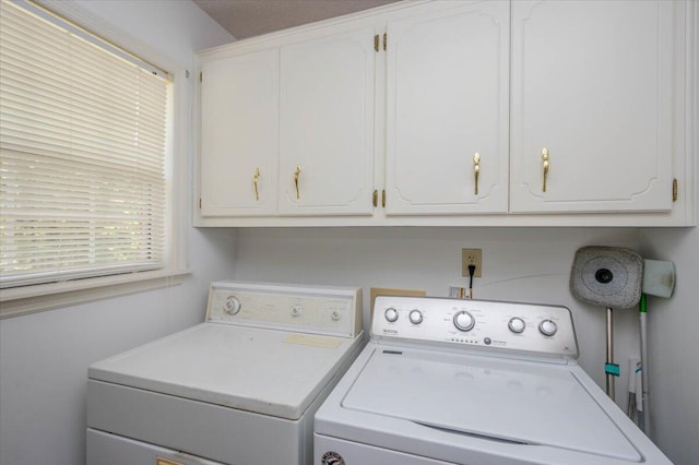 laundry room with cabinet space and washing machine and clothes dryer