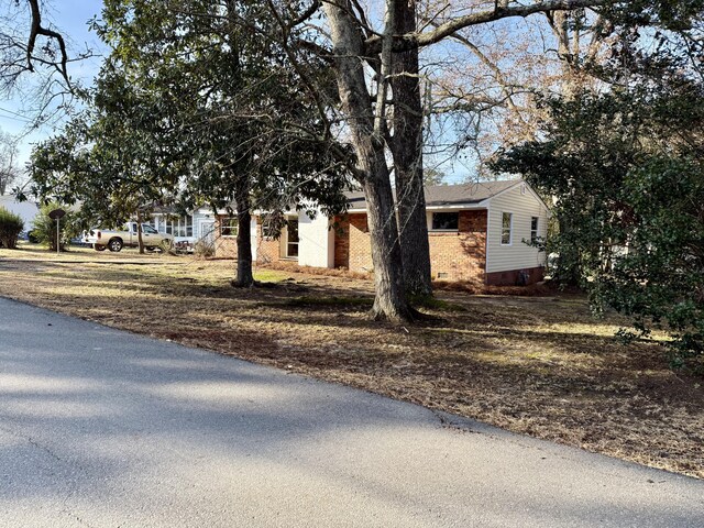 view of front of house featuring crawl space and brick siding