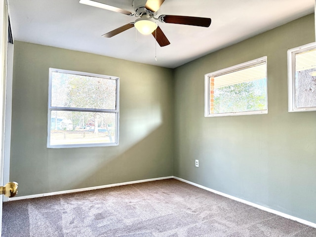 carpeted spare room with baseboards and ceiling fan