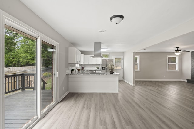 3630 Westhampton Dr, Augusta, GA 30907 - kitchen with stainless steel refrigerator with ice dispenser, a peninsula, open floor plan, light wood-style flooring, and white cabinetry