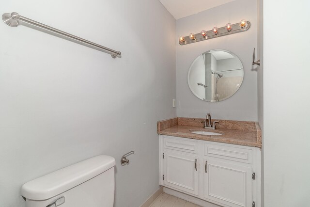 bathroom with tile patterned floors, vanity, and toilet