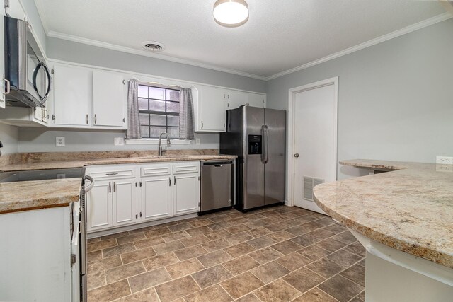 kitchen featuring white cabinetry, sink, stainless steel appliances, and ornamental molding