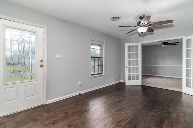 entrance foyer featuring french doors, a textured ceiling, dark hardwood / wood-style flooring, and ceiling fan