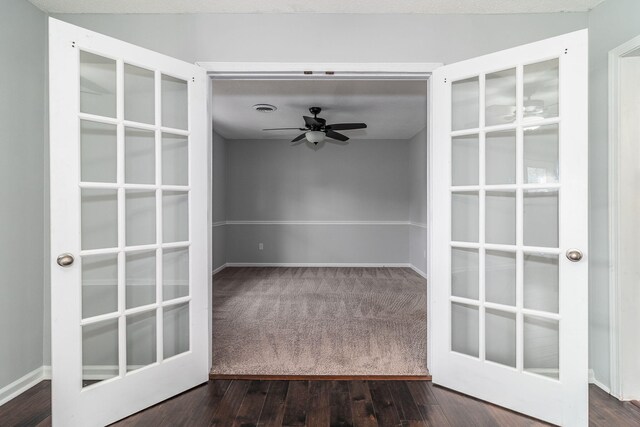 carpeted spare room featuring ceiling fan and french doors