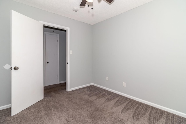 carpeted spare room featuring a textured ceiling and ceiling fan