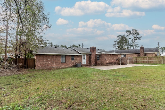 back of house with a patio area, a yard, and central air condition unit