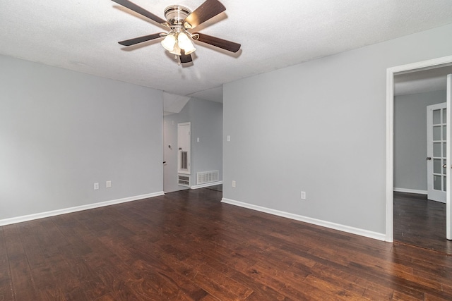 empty room featuring a textured ceiling, ceiling fan, and dark hardwood / wood-style floors