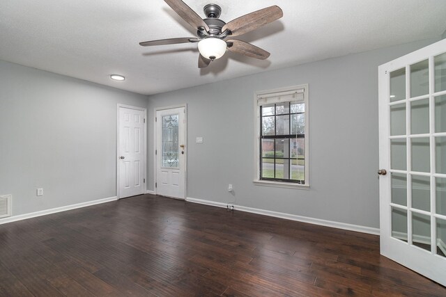 spare room featuring ceiling fan and dark hardwood / wood-style flooring