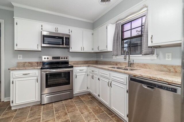 kitchen featuring white cabinetry, sink, ornamental molding, and appliances with stainless steel finishes