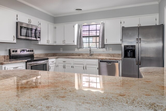 kitchen featuring white cabinets, sink, light stone countertops, and stainless steel appliances