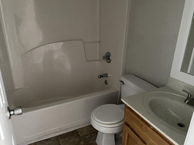 full bathroom featuring washtub / shower combination, vanity, toilet, and tile patterned flooring