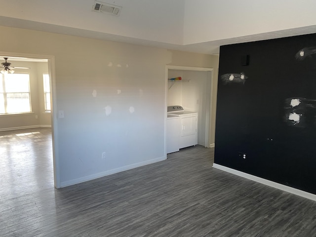 unfurnished room featuring ceiling fan, dark hardwood / wood-style flooring, and washing machine and clothes dryer