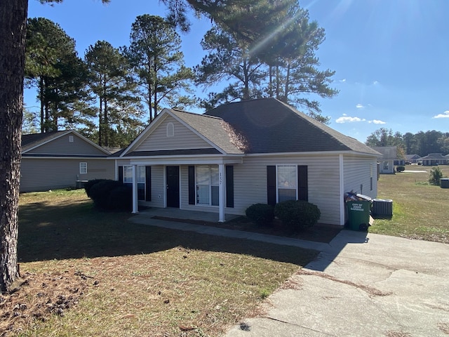 view of front facade with central AC and a front lawn