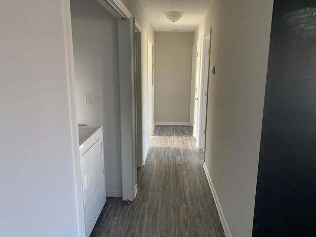 hall with dark hardwood / wood-style flooring and washer and clothes dryer