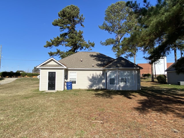 back of property featuring a yard and cooling unit