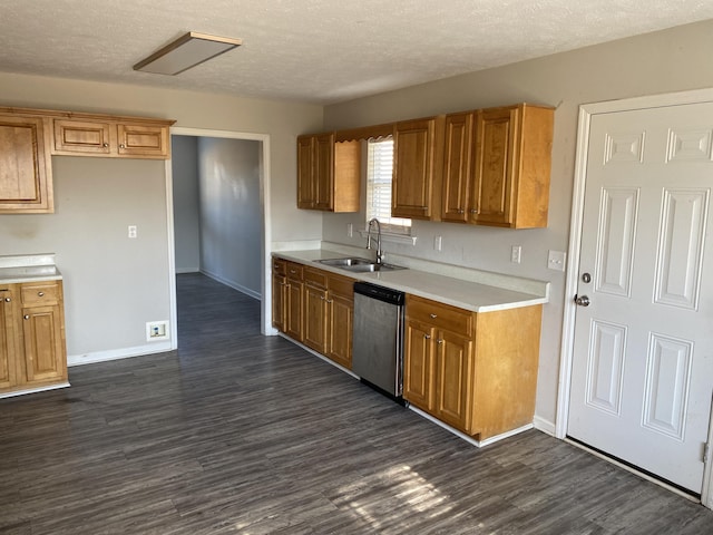 kitchen featuring dishwasher, a textured ceiling, dark hardwood / wood-style floors, and sink