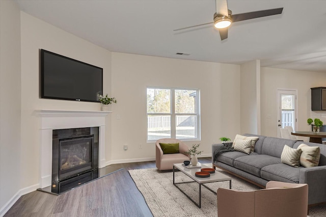 living room featuring ceiling fan, a healthy amount of sunlight, and wood-type flooring