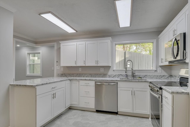 2417 Wilkshire Dr, Augusta, GA 30904 - kitchen featuring a peninsula, ornamental molding, appliances with stainless steel finishes, white cabinetry, and a sink