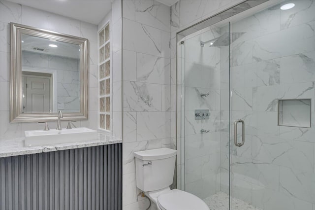 2417 Wilkshire Dr, Augusta, GA 30904 - bathroom with a stall shower, toilet, vanity, visible vents, and tile walls