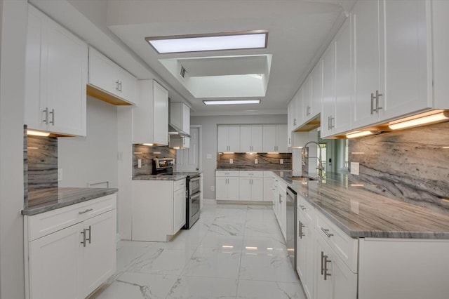 2417 Wilkshire Dr, Augusta, GA 30904 - kitchen featuring white cabinetry, marble finish floor, a sink, stone countertops, and appliances with stainless steel finishes