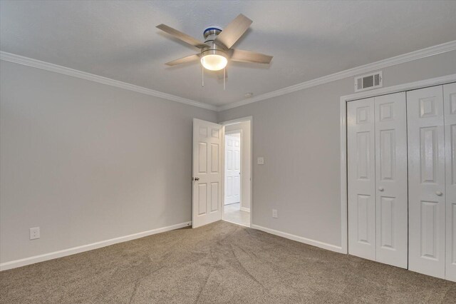 2417 Wilkshire Dr, Augusta, GA 30904 - unfurnished bedroom with a closet, crown molding, baseboards, visible vents, and carpet