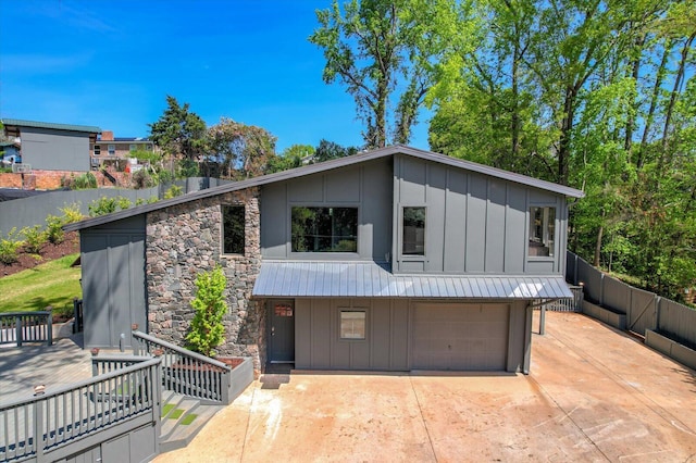 2417 Wilkshire Dr, Augusta, GA 30904 - view of front of property with concrete driveway, fence, stone siding, board and batten siding, and a garage