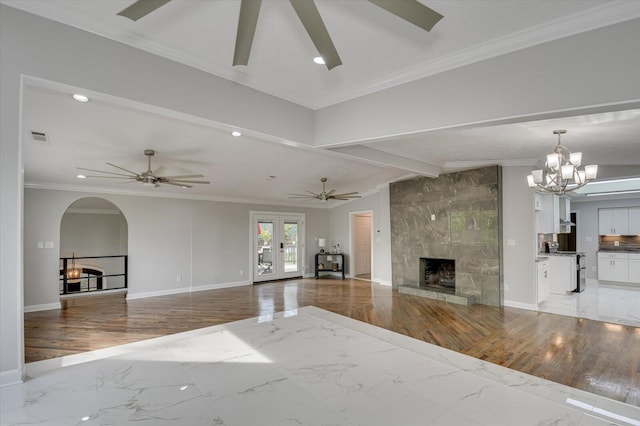 2417 Wilkshire Dr, Augusta, GA 30904 - unfurnished living room featuring a tiled fireplace, marble finish floor, ceiling fan with notable chandelier, and visible vents
