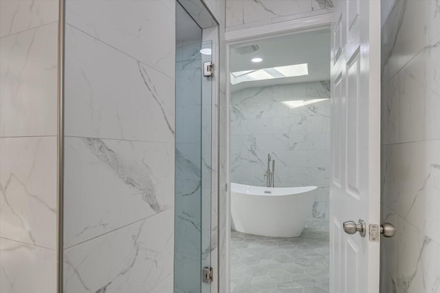 2417 Wilkshire Dr, Augusta, GA 30904 - bathroom featuring a soaking tub, tile walls, and visible vents
