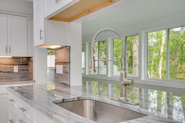 2417 Wilkshire Dr, Augusta, GA 30904 - kitchen featuring white cabinets, a sink, and light stone counters